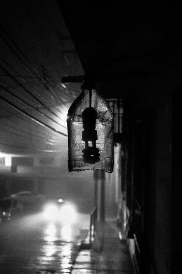 Rain-soaked street at night in black and white