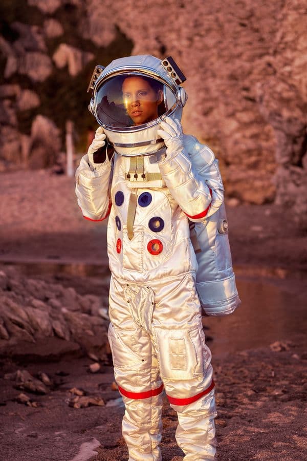 Astronaut standing on a rocky alien landscape