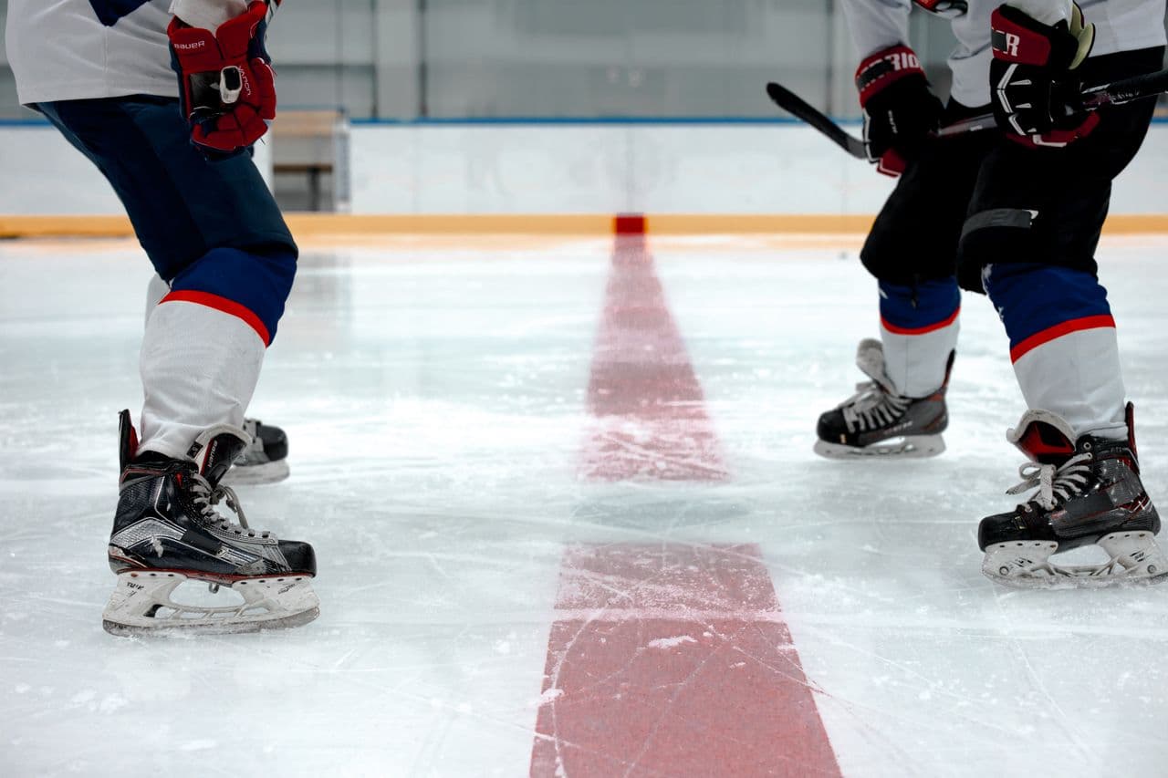 Hockey players lined up at the centre ice face-off